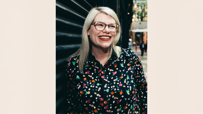 Smiling spectacled woman with blonde hair andred lipstick